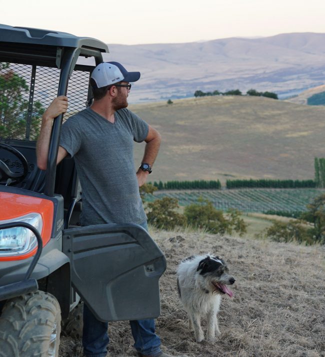 Man, dog and ATV in the field